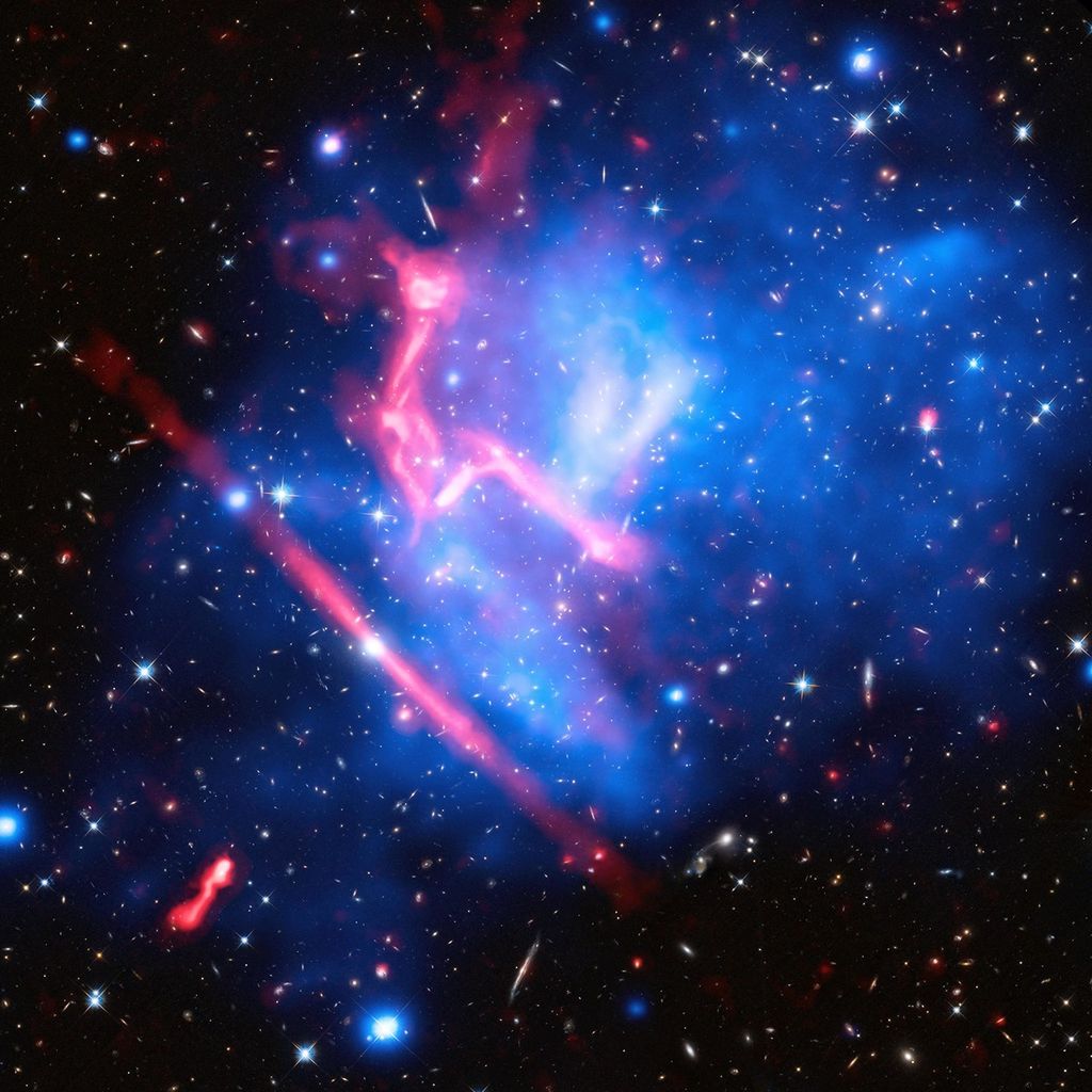 A black background is dotted with galaxies and a few foreground stars. Most of the center, from the lower-left to upper right, is filled with translucent blobs of various shades of blue, sometimes blended with purple, to denote temperature of matter. There are also a couple streaks/blobs of pinkish-red